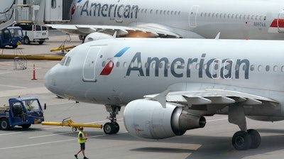 American Airlines passenger jets prepare for departure at Boston Logan International Airport, July 21, 2021.