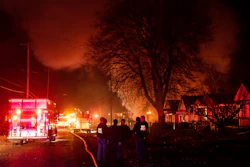 Emergency personnel are shown at the scene of a fire and explosion at a home in Flint, Mich., Monday night, Nov. 22, 2021. Three people were missing following the fire and explosion, authorities said.