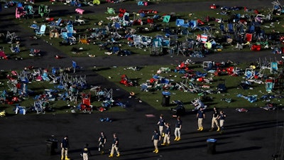 Investigators work at a festival grounds across the street from the Mandalay Bay Resort and Casino on Oct. 3, 2017, in Las Vegas after a mass shooting. The Nevada Supreme Court cited a state law that shields gun manufacturers from liability unless the weapon malfunctions in a new ruling that says they cannot be held responsible for the deaths in the 2017 mass shooting on the Las Vegas Strip.