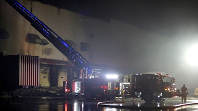 Firefighters work on cleanup after a fire ripped through a distribution center for the QVC home-shopping television network in Rocky Mount, N.C. on Saturday, Dec. 18, 2021. More than 300 employees were working at the facility when the fire was reported shortly after 2a.m. No injuries were immediately reported.