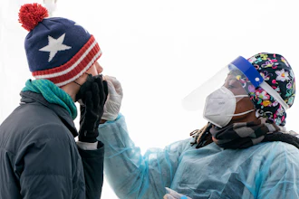 A man is swabbed for COVID-19 at a walk-up testing site at Farragut Square on Dec. 23, 2021, just blocks from the White House in Washington. The explosive increase in U.S. coronavirus case counts is raising alarm, but some experts believe the focus should instead be on COVID-19 hospital admissions. And those aren't climbing as fast.