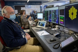 NASA James Webb Space Telescope Project Manager Bill Ochs monitors the progress of the observatory's second primary mirror wing as it rotates into position, the Space Telescope Science Institute, Baltimore, Jan. 8, 2022.