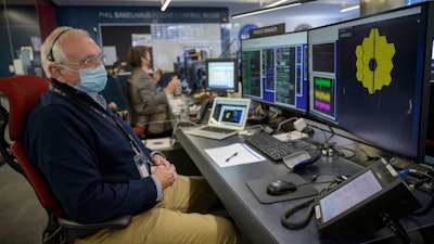 NASA James Webb Space Telescope Project Manager Bill Ochs monitors the progress of the observatory's second primary mirror wing as it rotates into position, the Space Telescope Science Institute, Baltimore, Jan. 8, 2022.