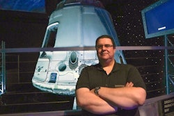 Kyle Hippchen poses in front of a SpaceX Dragon capsule at the Kennedy Space Center Visitor Complex, Cape Canaveral, Fla., Jan. 21, 2022.
