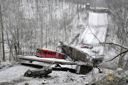 A Port Authority bus that was on a bridge when it collapsed Friday Jan. 28, 2022, is visible in Pittsburgh's East End. A two-lane bridge collapsed in Pittsburgh early Friday, prompting rescuers to rappel nearly 150 feet (46 meters) while others formed a human chain to help rescue multiple people from a dangling bus.
