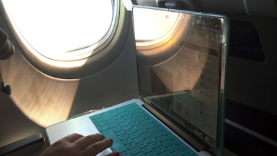 A passenger uses a laptop aboard a commercial airline flight from Boston to Atlanta on July 1, 2017. Concern about new high-speed wireless service interfering with airplanes appears to be easing. Federal safety regulators said Friday, Jan. 28, 2022 they have cleared the way for Verizon and AT&T to turn on more 5G towers.