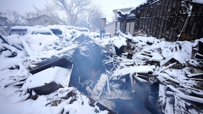 An overnight dumping of snow and frigid temperatures compounded the misery of hundreds of Colorado residents who started off the new year trying to salvage what remains of their homes after a wind-whipped wildfire tore through the Denver suburbs.