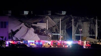An Amazon distribution center is heavily damaged after a strong thunderstorm moved through the area, Dec. 10, 2021, in Edwardsville, Ill. The family of a delivery driver who died last month when a tornado collapsed the central Illinois Amazon facility where he worked filed a wrongful death lawsuit Monday, Jan. 17, 2022 in Madison County.