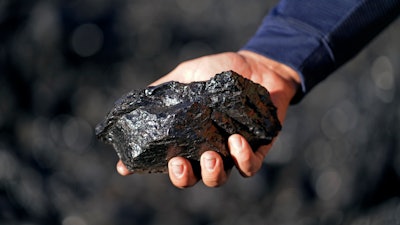 Sean Hovorka, production superintendent Trapper Mining, holds coal from the Trapper Mine on Thursday, Nov. 18, 2021, in Craig, Colo. Hovorka, also recently elected member of the town's city council, sees a future in mining because of renewables.