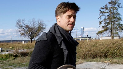Brad Pitt walks past one of the first homes built in New Orleans by his Make It Right Foundation in this 2008 photo.
