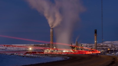 In this photo taken with a slow shutter speed, taillights trace the path of a motor vehicle at the Naughton Power Plant, Thursday, Jan. 13, 2022 in Kemmerer, Wyo. While the power plant will be closed in 2025, Bill Gates' company TerraPower announced it had chosen Kemmerer for a nontraditional, sodium-cooled nuclear reactor that will bring on workers from a local coal-fired power plant scheduled to close soon.