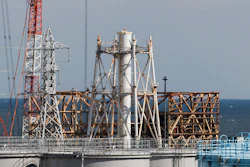 The damaged Unit 1 reactor, back, and the exhaust stack shared with the Unit 1 and 2 reactors at the Fukushima Daiichi nuclear power plant, Okuma town, Japan, Feb. 27, 2021.