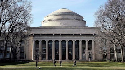 Students walk past the 'Great Dome' atop Building 10 on the Massachusetts Institute of Technology campus, April 3, 2017, in Cambridge, Mass.