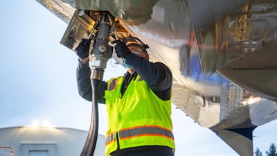 Aviation maintenance technician loads sustainable aviation fuel into the 2021 Boeing ecoDemonstrator.