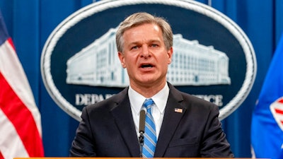 FBI Director Christopher Wray speaks at a news conference at the Justice Department in Washington, on Nov. 8, 2021. Wray says the threat to the West from the Chinese government is 'more brazen' and damaging than ever before. In a speech on Jan. 31, 2022, at the Reagan Presidential Library in California, Wray accused Beijing of stealing American ideas and innovation and launching massive hacking operations.