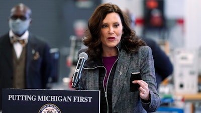 Michigan Gov. Gretchen Whitmer addresses business leaders, Monday, Dec. 20, 2021, in Detroit. Gov. Whitmer's office has announced plans for the first electric vehicle charging road in the U.S. to be built in Detroit by 2023.