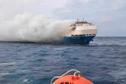 In this undated photo provided by the Portuguese Navy on Feb. 18, 2022, smoke billows from the burning Felicity Ace car transport ship as seen from the Portuguese Navy NPR Setubal ship southeast of the mid-Atlantic Portuguese Azores Islands.