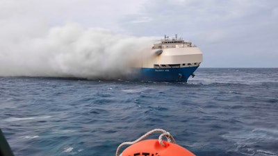 In this undated photo provided by the Portuguese Navy on Feb. 18, 2022, smoke billows from the burning Felicity Ace car transport ship as seen from the Portuguese Navy NPR Setubal ship southeast of the mid-Atlantic Portuguese Azores Islands.