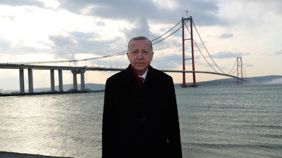Turkish President Recep Tayyip Erdogan poses for photos in front of the 1915 Canakkale Bridge, Çanakkale, Turkey, March 18, 2022.