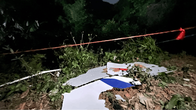 In this photo released by China's Xinhua News Agency, debris is seen at the site of a plane crash in Tengxian County in southern China's Guangxi Zhuang Autonomous Region, Tuesday, March 22, 2022. A China Eastern Boeing 737-800 with more than 100 people on board crashed in a remote mountainous area of southern China on Monday, officials said, setting off a forest fire visible from space in the country's worst air disaster in nearly a decade.
