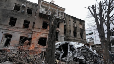 A damaged building and car after recent shelling, in the center of Kharkiv, Ukraine, Sunday, March 27, 2022.