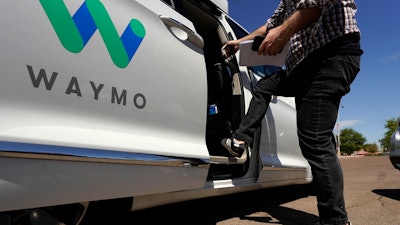 A Waymo minivan arrives to pick up passengers in Mesa, Ariz., April 7, 2021.