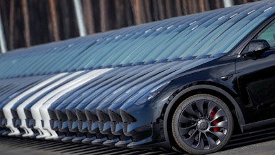 Tesla cars are parked at the construction site of the new Tesla Gigafactory for electric cars in Gruenheide near Berlin, Germany, Friday, March 18, 2022.