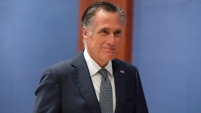 Sen. Mitt Romney, R-Utah, arrives to watch a speech by Ukrainian President Volodymyr Zelenskyy live-streamed into the U.S. Capitol, in Washington, March 16, 2022. Lawmakers seemed on the brink of clinching a bipartisan compromise Thursday, March 31, to provide a fresh $10 billion to combat COVID-19. Romney said bargainers had reach an agreement in principle on a package but said it was still being drafted. Other senators were less definitive but none contested that a deal was near.