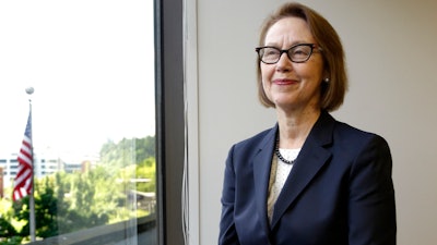 In this July 13, 2016 file photo, Oregon Attorney General Ellen Rosenblum poses for a photo at her office in Portland, Ore. The state of Oregon has sued an Illinois-based COVID-19 testing company, saying its owners took millions of dollars in federal funds and insurance money for themselves and boasted about buying a mansion and expensive sports cars. Rosenblum sued the Center for Covid Control, or CCC, and its testing partner, Doctors Clinical Laboratory, for deceptively marketing testing services and for violating Oregon's Unlawful Trade Practices Act.