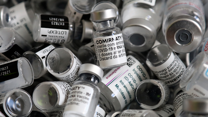 In this file photo dated Saturday, May 15, 2021, empty vials of the Pfizer-BioNTech COVID-19 vaccine lie in a box during a vaccine campaign at the Vaccine Village in Ebersberg near Munich, Germany. Germany's health ministry said Monday that the country may have to discard 3 million doses of expired COVID-19 vaccine by the end of June.