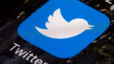 The Twitter icon is displayed on a mobile phone in Philadelphia on April 26, 2017. Twitter said in a statement Friday, April 15, 2022, that its board of directors has unanimously adopted a “poison pill” defense in response to Tesla CEO Elon Musk’s proposal to buy the company and take it private.