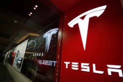A sign bearing the company logo outside a Tesla store in Cherry Creek Mall in Denver, Feb. 9, 2019. Tesla is recalling nearly nearly 595,000 vehicles in the U.S., Thursday, April 14, 2022, most for a second time, because a “Boombox” function can play sounds over an external speaker and obscure audible warnings for pedestrians.