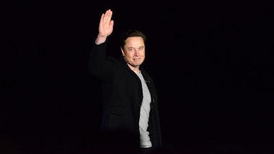 Elon Musk waves while providing an update on SpaceX's Starship, Thursday, Feb. 10, 2022, near Brownsville, Texas. In April 2022, a group of Tesla shareholders suing Musk over some 2018 tweets about taking the company private is asking a federal judge to order him to stop commenting on the case.