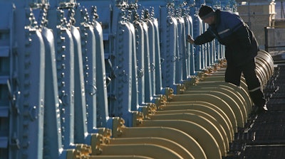 A Belarusian worker on duty at a gas compressor station of the Yamal-Europe pipeline near Nesvizh, some 130 km (81 miles) southwest of the capital Minsk, Belarus, Dec. 29, 2006. Officials in Poland and Bulgaria say Russia is suspending their countries’ natural gas deliveries starting on Wednesday. The governments of the two European countries said Tuesday April 26, 2022, that Russian energy giant Gazprom informed them it was halting gas supplies.