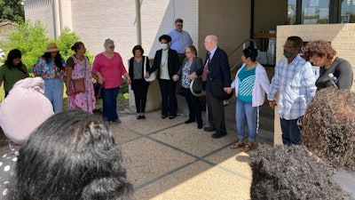 Opponents of a grain elevator proposed along the Mississippi River pray outside a courthouse in Edgard, La., April 28, 2022.