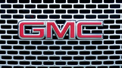 The GMC logo is displayed on the grill of a truck at a GMC dealership in Warminster, Pa., Tuesday, April 26, 2022. General Motors’ net income declined in the first quarter of 2022, as the automaker sold fewer cars and trucks worldwide, although higher prices helped boost revenue, especially in North America.