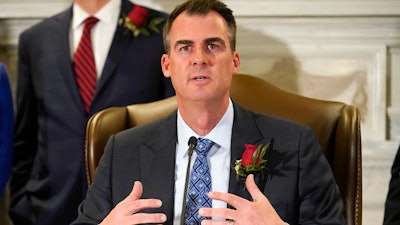 Oklahoma Gov. Kevin Stitt speaks at a signing ceremony to sign into law a bill, Tuesday, April 12, 2022, in Oklahoma City. The governor is asking lawmakers to approve a massive package of financial incentives to help lure an unnamed company to the state. Stitt made the request at a news conference on Monday, April 18. He told reporters he was prohibited from naming the company or the total cost of the package.