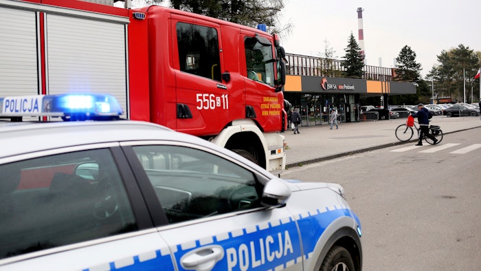 A police car and a firefighters' truck before the Pniowek coal mine in Pawlowice, southern Poland, on Wednesday, April 20, 2022, where two underground methane explosions killed five people and injured more than 20 early Wednesday.