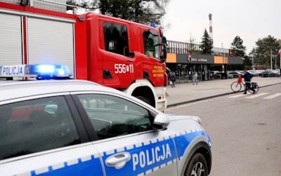 A police car and a firefighters' truck before the Pniowek coal mine in Pawlowice, southern Poland, on Wednesday, April 20, 2022, where two underground methane explosions killed five people and injured more than 20 early Wednesday.