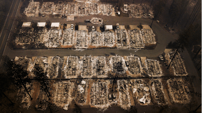 This Nov. 15, 2018, aerial file photo shows the remains of residences leveled by the Camp wildfire in Paradise, Calif.