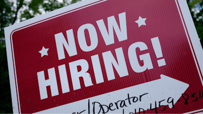 A 'now hiring' sign is posted in Garnet Valley, Pa., Monday, May 10, 2021. Applications for unemployment benefits inched down last week, Thursday, April 21, 2022, as the total number of Americans collecting aid fell to its lowest level in more than 50 years.