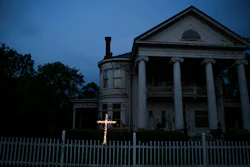 An illuminated cross stands in front of a residence near downtown Dawson, Ga., on April 17, 2020. Both Rocky Ford, Colorado, and Dawson, Georgia, were classified as urban areas after the 2010 census because they had populations over 2,500 residents. Under new criteria posted this spring by the U.S. Census Bureau, these communities would no longer be designated as urban. The new criteria require places to have 2,000 housing units, which is equivalent to 5,000 residents, to be considered an urban area.