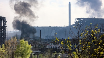 Smoke rises from the Metallurgical Combine Azovstal in Mariupol, in territory under the government of the Donetsk People's Republic, eastern Ukraine, Wednesday, May 4, 2022.