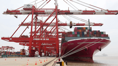 In this photo released by Xinhua News Agency, a container ship from Japan is anchored at the container dock of Shanghai's Yangshan Port in east China on April 27, 2022. China's export growth tumbled in April after Shanghai and other industrial cities were shut down to fight virus outbreaks.