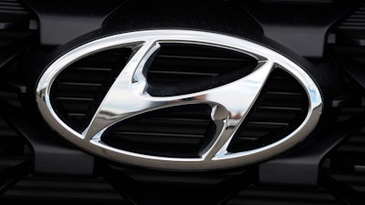 The Hyundai logo shines off the grille of an unsold vehicle at a Hyundai dealership Sunday, Sept. 12, 2021, in Littleton, Colo.