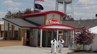 Workers leave a Tyson Foods pork processing plant, Logansport, Ind., May 7, 2020.