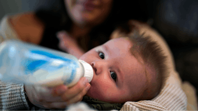 Ashley Maddox feeds her 5-month-old son, Cole, with formula she bought through a Facebook group of mothers in need Thursday, May 12, 2022, in Imperial Beach, Calif. 'I connected with a gal in my group and she had seven cans of the formula I need that were just sitting in her house that her baby didn't need anymore,' she said. 'So I drove out, it was about a 20-minute drive and picked it up and paid her. It was a miracle.'