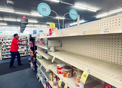 An employee walks near empty shelves where baby formula would normally be located at a CVS in New Orleans on Monday, May 16, 2022. President Joe Biden's administration has announced new steps to ease the national shortage of baby formula, including allowing more imports from overseas.