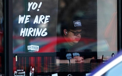 A hiring sign is displayed at a restaurant in Schaumburg, Ill., April 1, 2022. Employers posted a record 11.5 million job openings in March, more evidence of a tight labor market that has emboldened millions of American workers to leave their jobs and contributed to the biggest surge in inflation in four decades. A record 4.5 million Americans quit their jobs in February — a sign that they are confident they can find better pay or working conditions elsewhere.