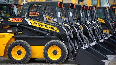 In this photo made on Friday, March 28, 2014, earth moving and construction equipment by New Holland, a CNH Industrial brand, is stored on a lot at the Highway Equipment Company in Zelienople, Pa. More than 1,000 workers at CNH Industrial plants in Wisconsin and Iowa went on strike Monday, May 2, 2022, in search of a better deal with the company that makes agriculture and construction equipment.